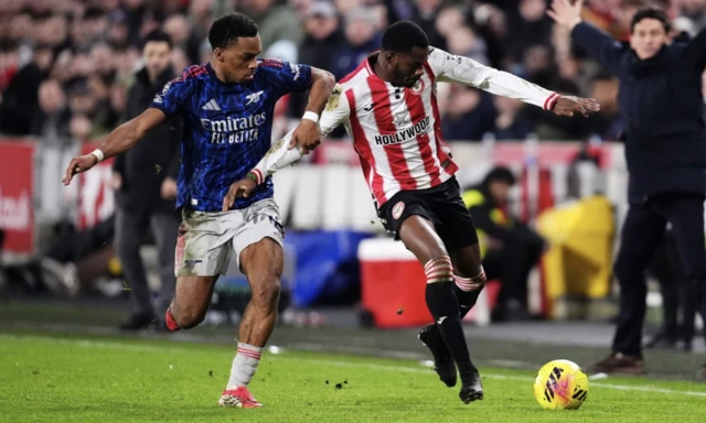 Arsenal's Jurrien Timber (left) and Brentford's Dango Ouattara battle for the ball