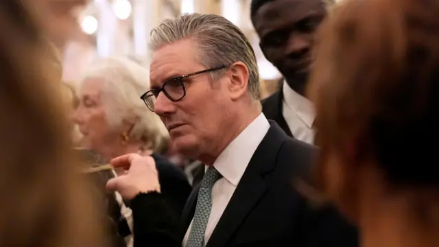Keir Starmer surrounded by people as he speaks with guests during a reception at Windsor Castle