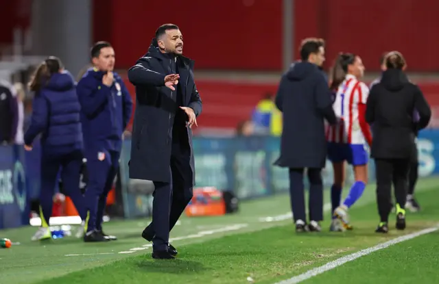 Fiamma Benitez in background on side of pitch