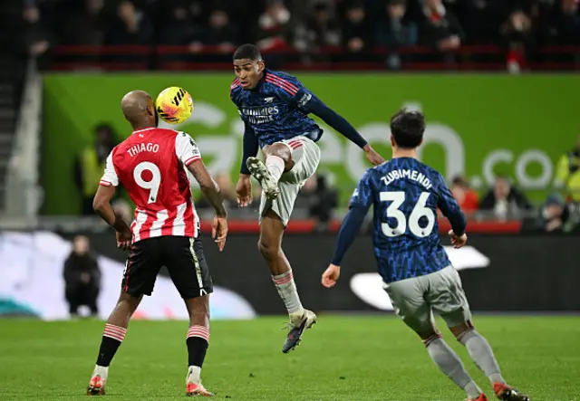 Cristhian Mosquera of Arsenal kicks the ball whilst under pressure from Igor Thiago