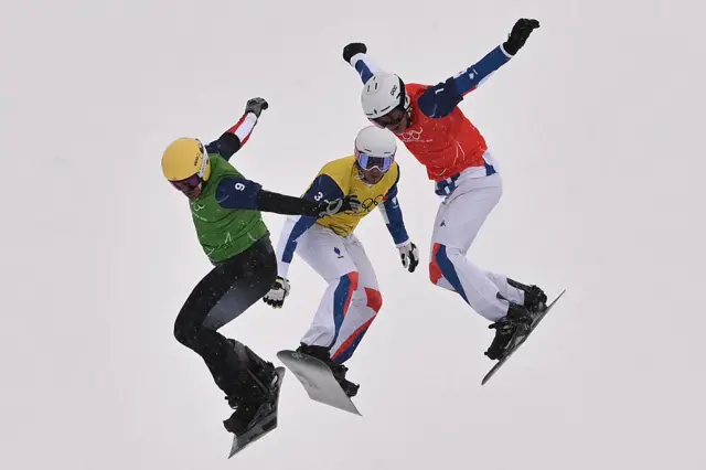 Action from the men's snowboard cross competition