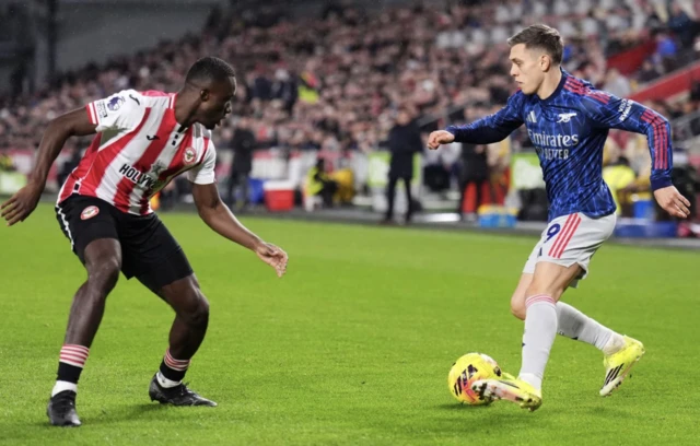 Arsenal's Leandro Trossard (right) and Brentford's Michael Kayode battle for the ball