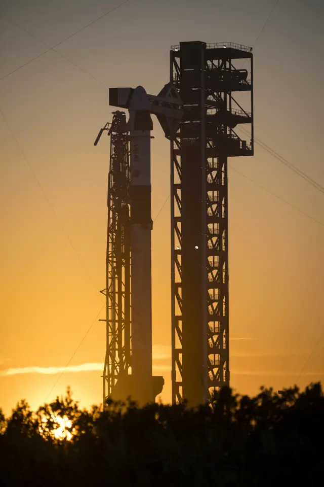 A SpaceX Falcon 9 rocket with the company's Dragon spacecraft on top is seen on the launch pad at sunset at Space Launch Complex 40 as preparations continue for the Crew-12 mission February 10, 2026