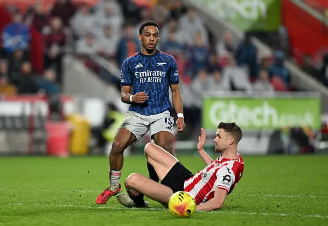 Jurrien Timber of Arsenal is challenged by Kristoffer Ajer