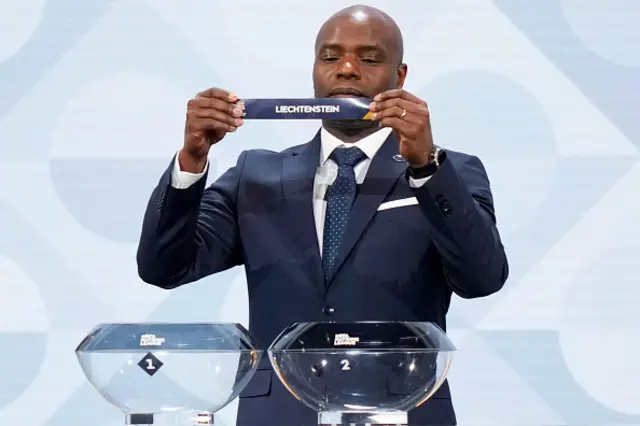 Former Belgium international Mbo Mpenza picks up the paper slip for Liechtenstein
