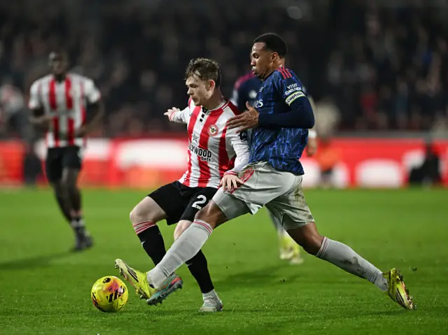 Keane Lewis-Potter of Brentford is challenged by Gabriel
