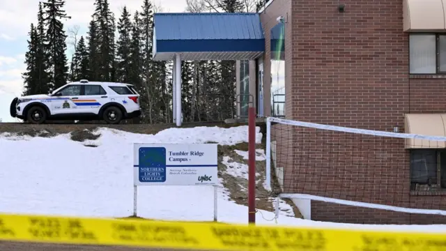 A police car parked outside the school in Tumbler Ridge