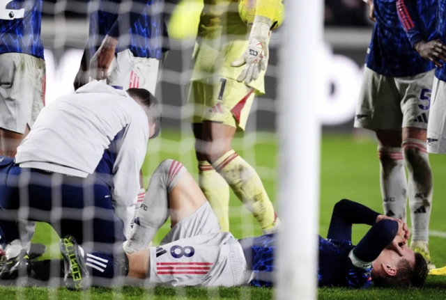 Arsenal's Martin Odegaard reacts after going down injured