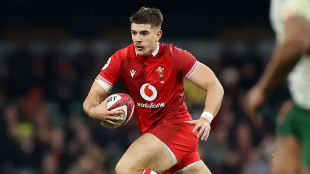 Joe Hawkins runs with the ball for Wales