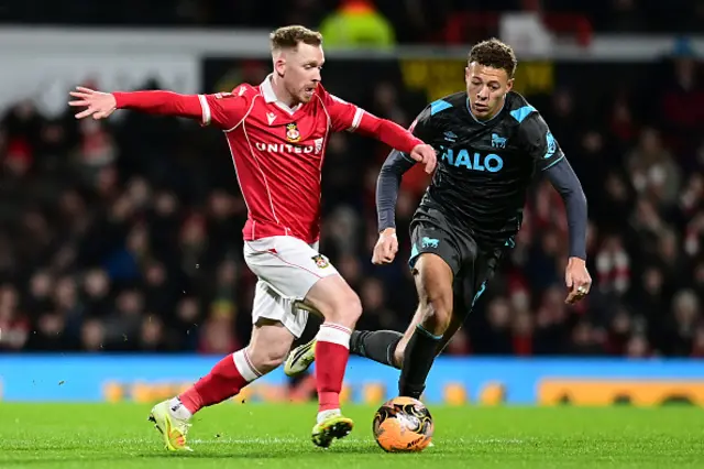 Wrexham's Lewis O'Brien vies for possession with Ipswich Town's Kasey McAteer during the Emirates FA Cup Fourth Round match between Wrexham and Ipswich Town