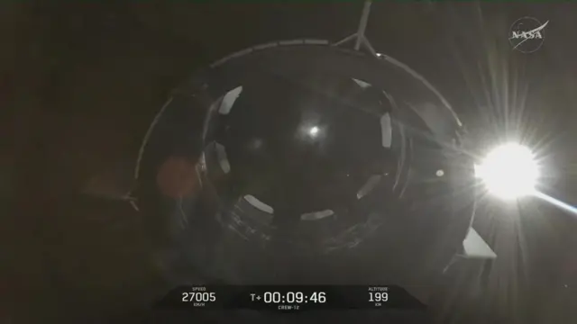 A booster is seen coming off the Dragon capsule as it continues its journey towards the International Space Station