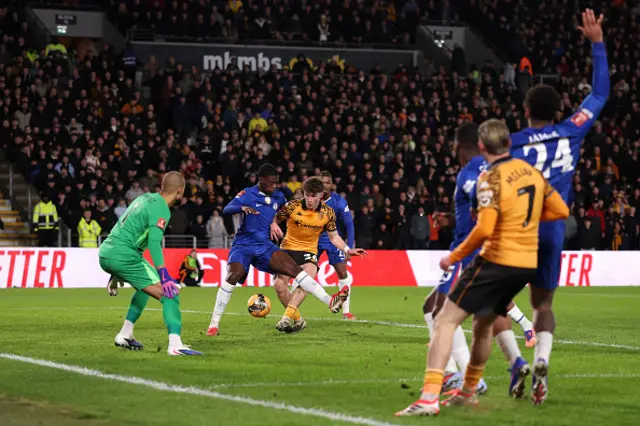 Lewis Koumas of Hull City takes a shot whilst under pressure from Mamadou Sarr