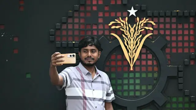 Man takes selfie outside office of the BNP in Dhaka