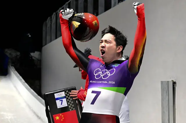 China's Wenhao Chen celebrates his fourth run in the men's skeleton