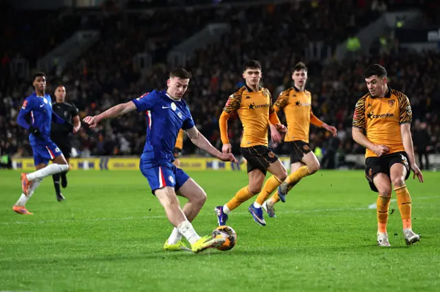 Liam Delap of Chelsea takes a shot whilst under pressure from John Egan