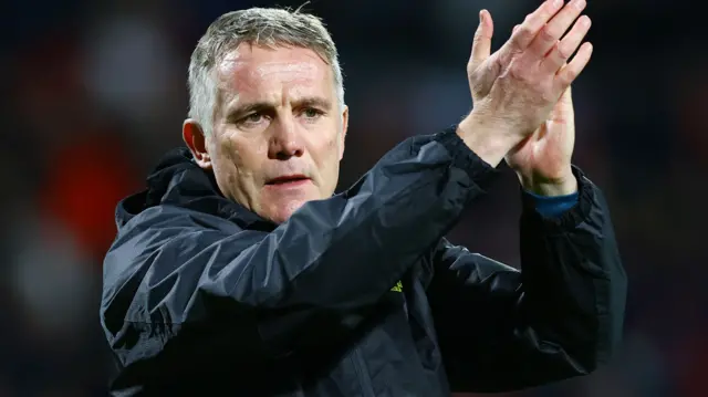 Wrexham manager Phil Parkinson clapping towards supporters.