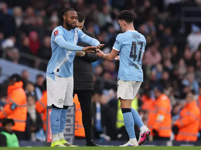Semenyo low fives Foden as he comes on