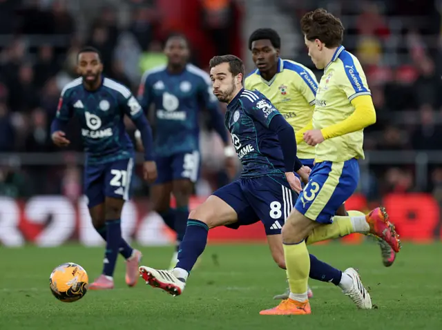Winks dribbles and lays off the ball in midfield
