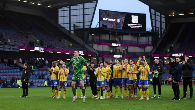 Mansfield players celebrate on the pitch at Turf Moor after a 2-1 over Burnley in the FA Cup fourth round
