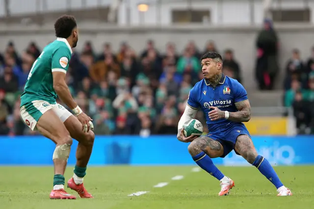 Monty Ioane carries the ball with Robert Baloucoune coming in to make a tackle