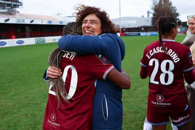 Guarino hugs Asseyi after the Brighton win