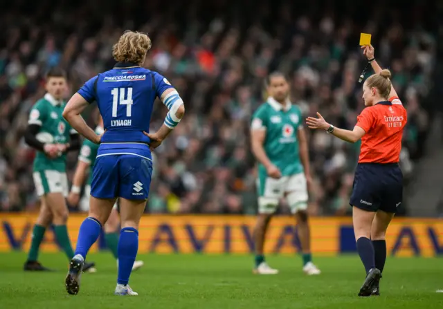 Hollie Davidson shows Italy's Louis Lynagh a yellow card against Ireland
