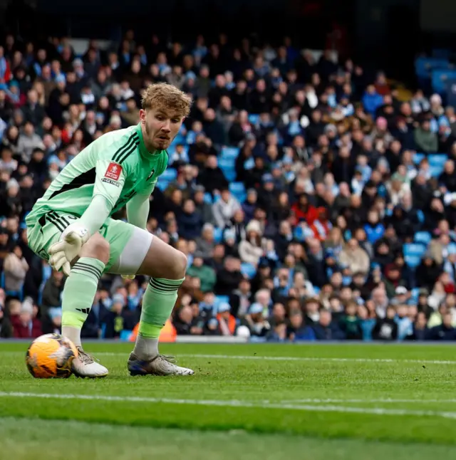 Alfie Dorrington  watches the ball roll past him