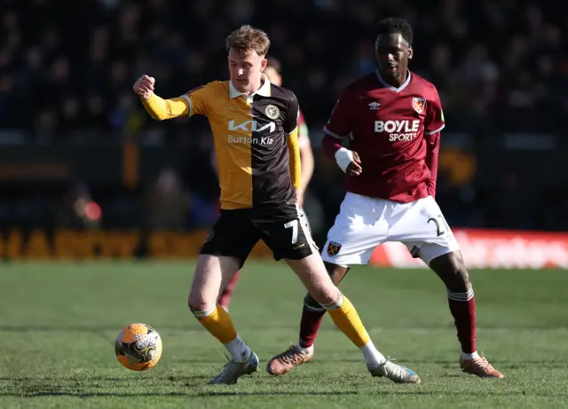 Burton Albion's Jj Mckiernan in action with West Ham United's Soungoutou Magassa