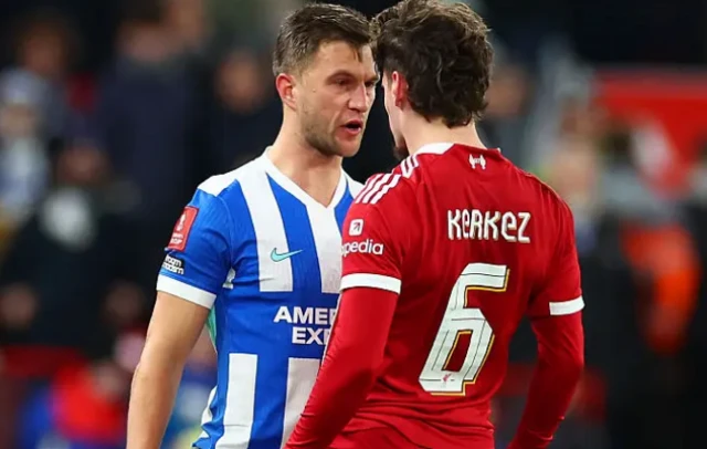 Milos Kerkez of Liverpool clashes with Pascal Gross of Brighton