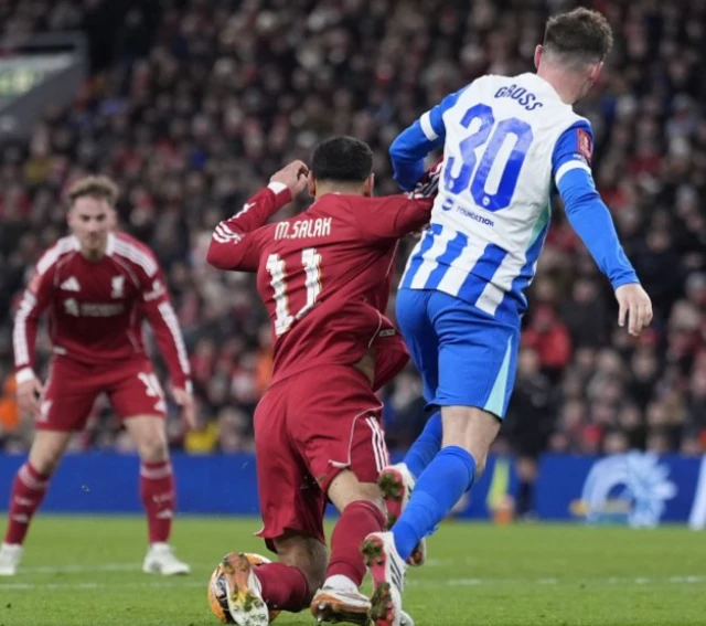 Liverpool's Mohamed Salah is fouled and wins a penalty