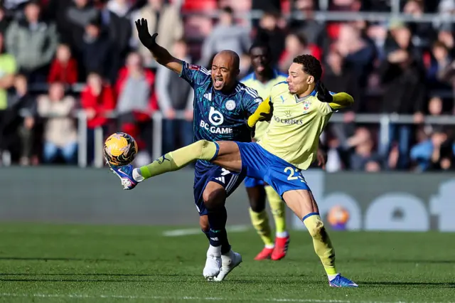Ayew battles for the ball