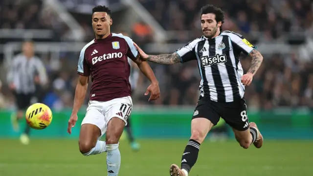 Aston Villa's Ollie Watkins and Newcastle's Sandro Tonali battle for possession