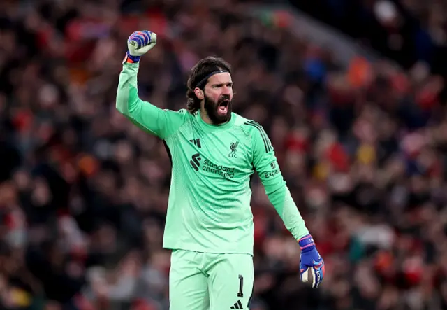 Alisson Becker of Liverpool celebrates after Mohamed Salah