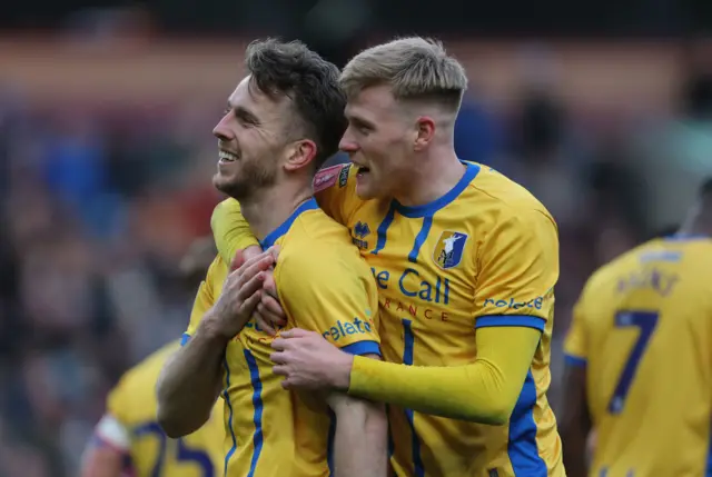 hys Oates (left) celebrates scoring their side's first goal of the game