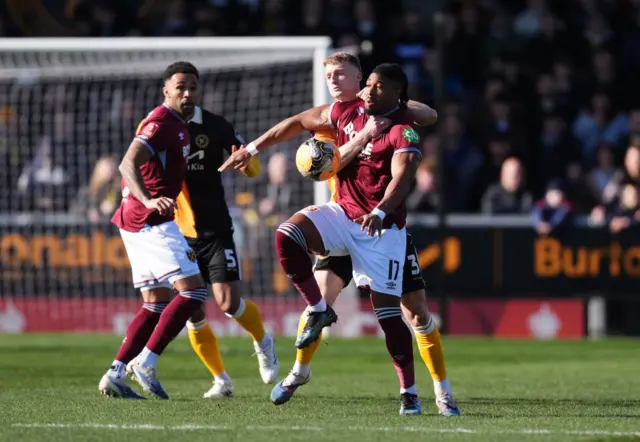 Traore is challenged robustly in midfield