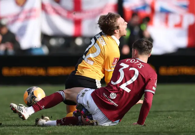 Potts flies into  a tackle on Larsson