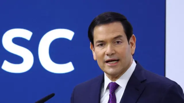 Rubio speaks into a microphone on stage at the security summit