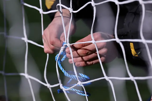 Burton staff member fixes the net pre-kick off