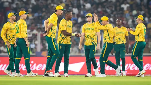 Lungi Ngidi of South Africa celebrates the wicket of Daryl Mitchell of New Zealand with teammates