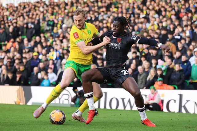 Norwich and West Brom players tussle for the ball