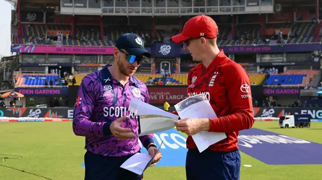 : The team captains Richie Berrington of Scotland and Harry Brook of England exchange team lists