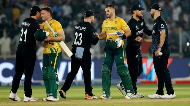 : Aiden Markram and David Miller of South Africa celebrate and shake hands with New Zealand player