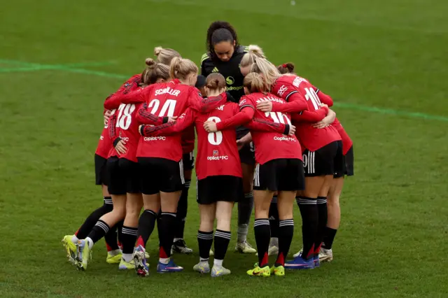 : Players of Manchester United huddle prior to the second half