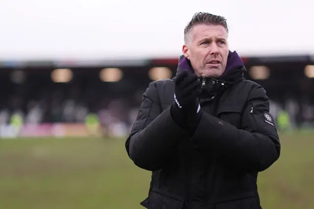 Rob Edwards, Manager of Wolverhampton Wanderers, acknowledges the fans