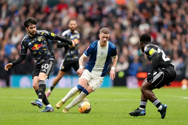 Jay Stansfield of Birmingham City runs with the ball under pressure from Facundo Buonanotte