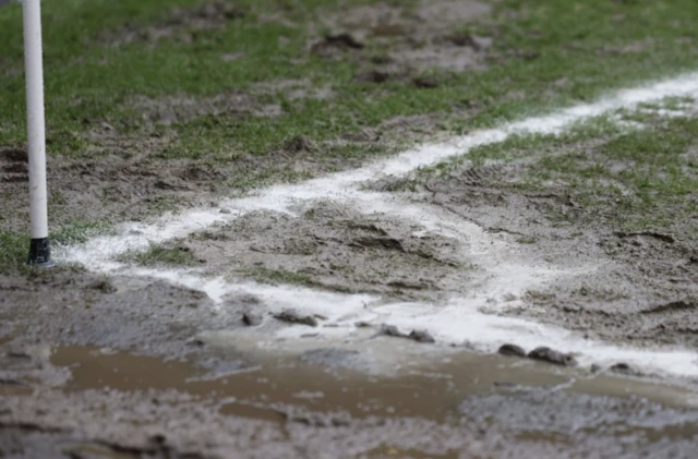A muddy area around a corner flag