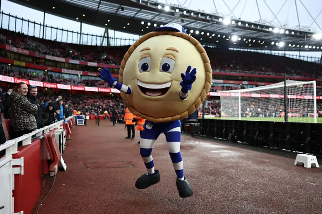 Crusty the Pie, mascot of Wigan Athletic interacts