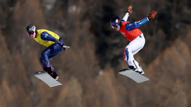 Snowboarders in action