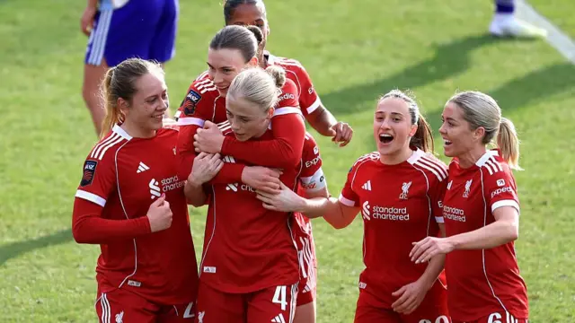 : Grace Fisk of Liverpool celebrates scoring her team's third goal with teammates