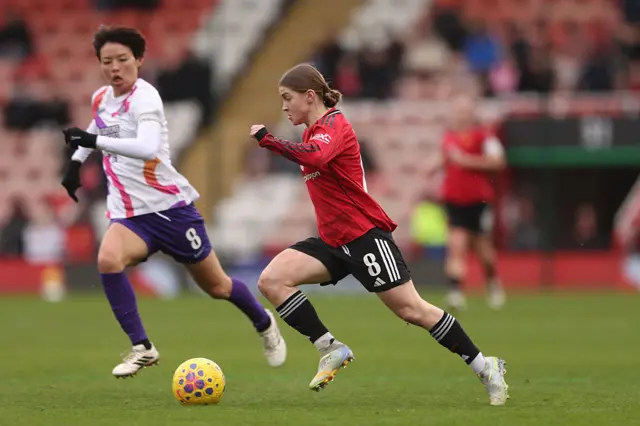 Jess Park of Manchester United runs with the ball under pressure from Saki Kumagai of London City Lionesses